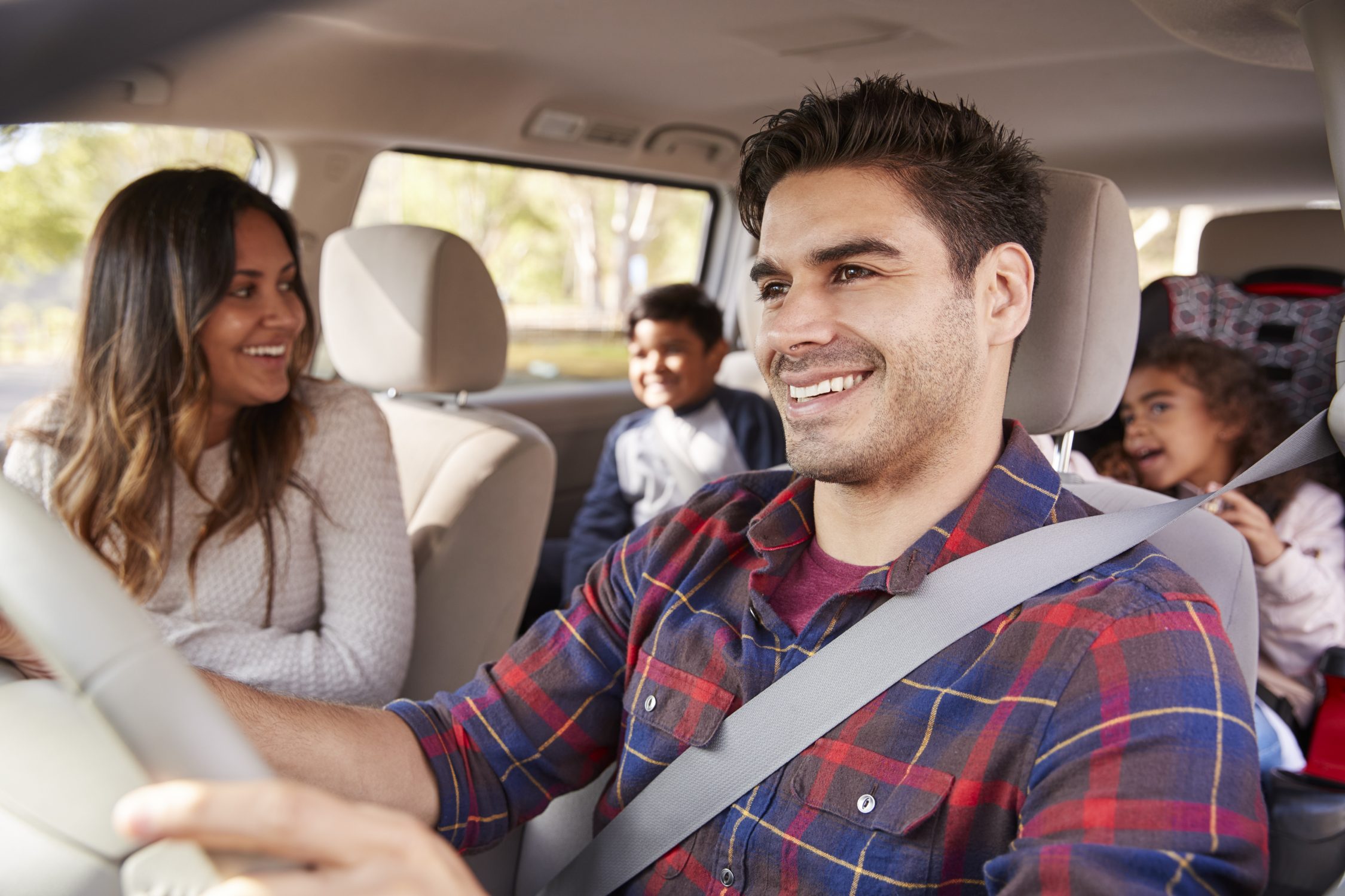 a group of people sitting around a car